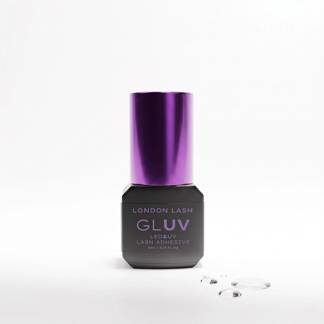London Lash GLUV LED & UV Lash Adhesive 5ml bottle with a metallic purple cap alongside clear adhesive droplets on a white background.