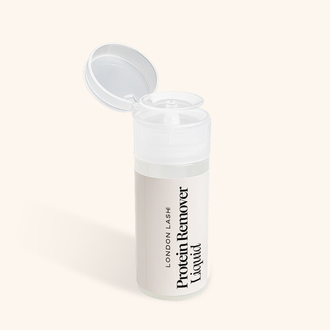 Clear container with &#39;London Lash Protein Remover Liquid&#39; text on a beige background